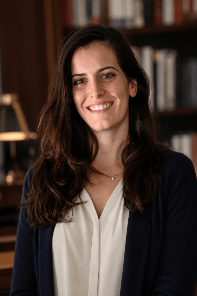 Official Author Photo of Patricia Morais Professional author headshot of Patricia Morais smiling in an elegant library, wearing timeless business-casual attire, with natural lighting and a warm, approachable expression.